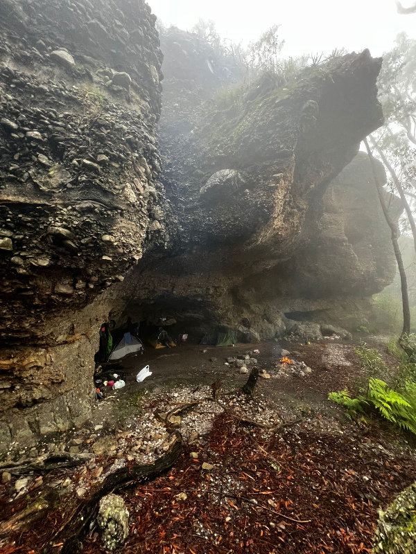 Camping under a cave, shelter from the rain — Morton National Park
